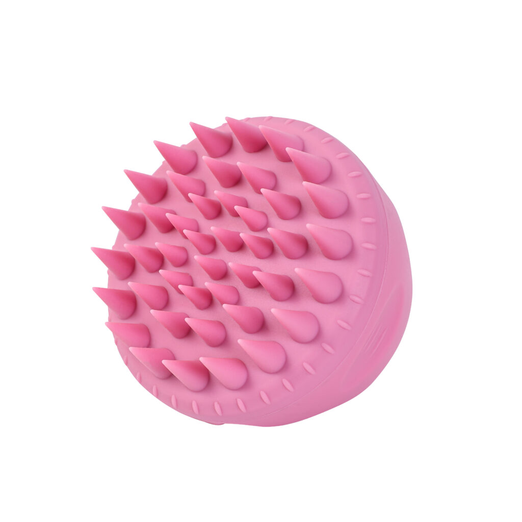 Spód różowej szczotki Sister Young AURA Pink z wypustkami masującymi rozmieszczonymi na okrągłej podstawie.