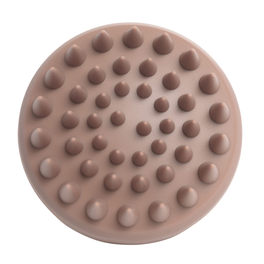 Spód szczotki Sister Young AURA Cinnamon Mocha z wypustkami masującymi rozmieszczonymi na okrągłej podstawie.