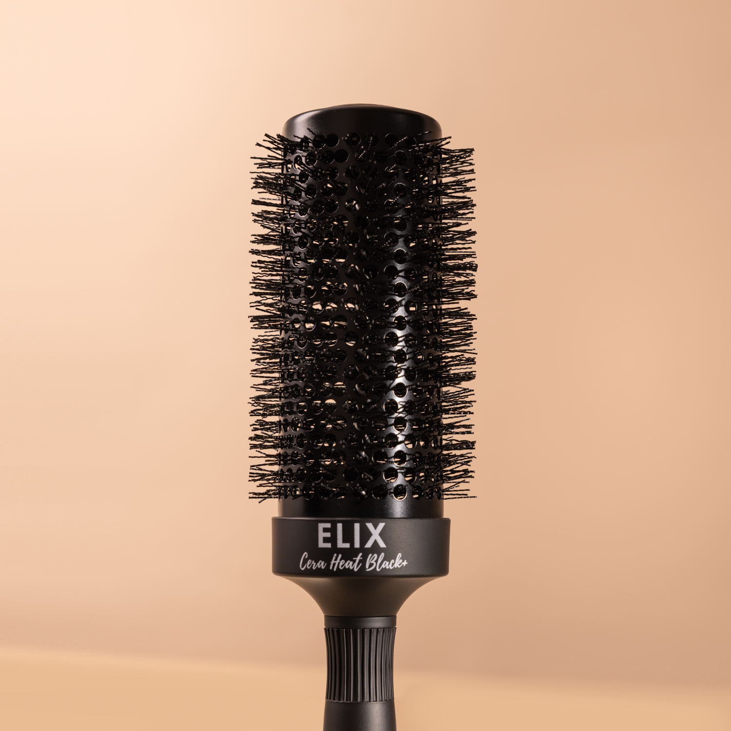 Szczotka Sister Young ELIX BLACK+ 53 mm leżąca na beżowym tle – widok od strony główki